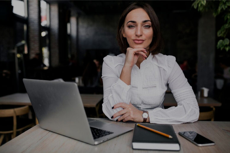 A full-time financial outsourcings services professional cups her chin while looking on. 