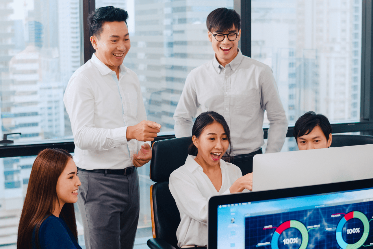 Team of finance professionals using accounting software in an outsourced BPO setup