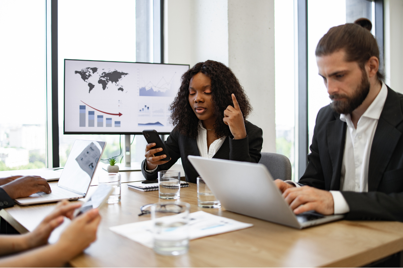 Business team analyzing reports, showing outsourcing finance services with a finance BPO company.