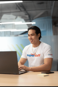 An outsource bookkeeping professional is looking at his laptop.